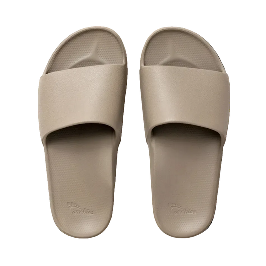 Pair of beige slides on a white background
