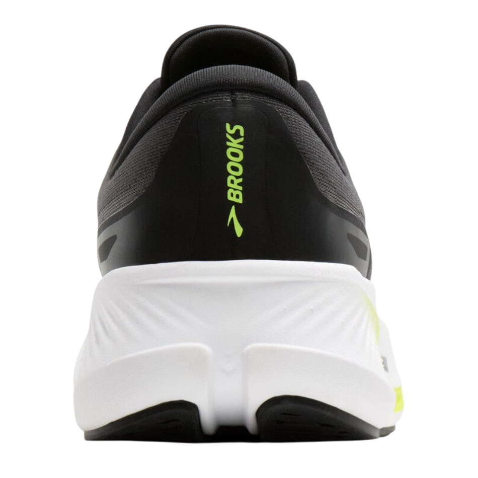 Up & Running Brooks Revel Max men's running shoe in black and white with neon yellow accents, rear view.