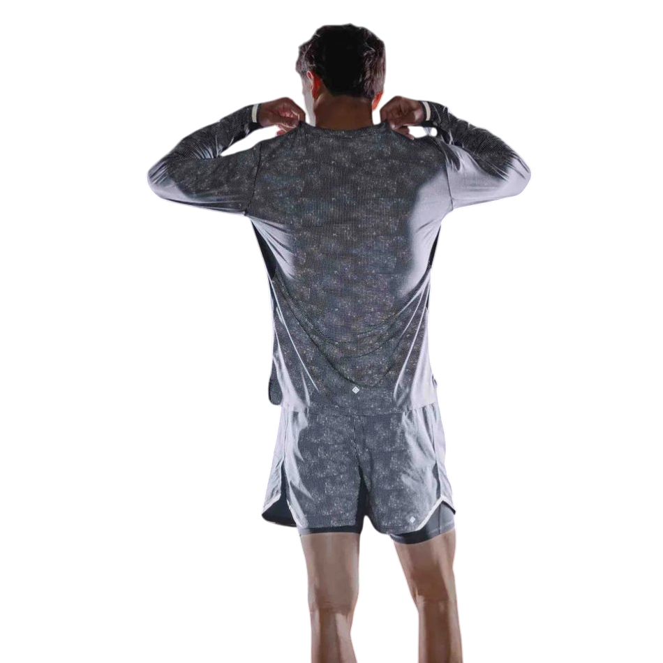 Up & Running Ronhill men's black reflective long-sleeved running tee viewed from the back against a dark background