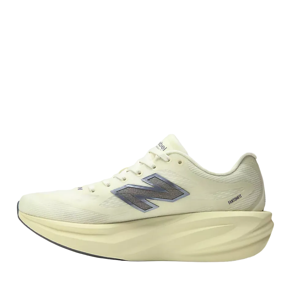 A New Balance running shoe in a light pistachio green colourway, featuring a thick sculpted matching sole and a metallic silver 'N' logo on the side.
