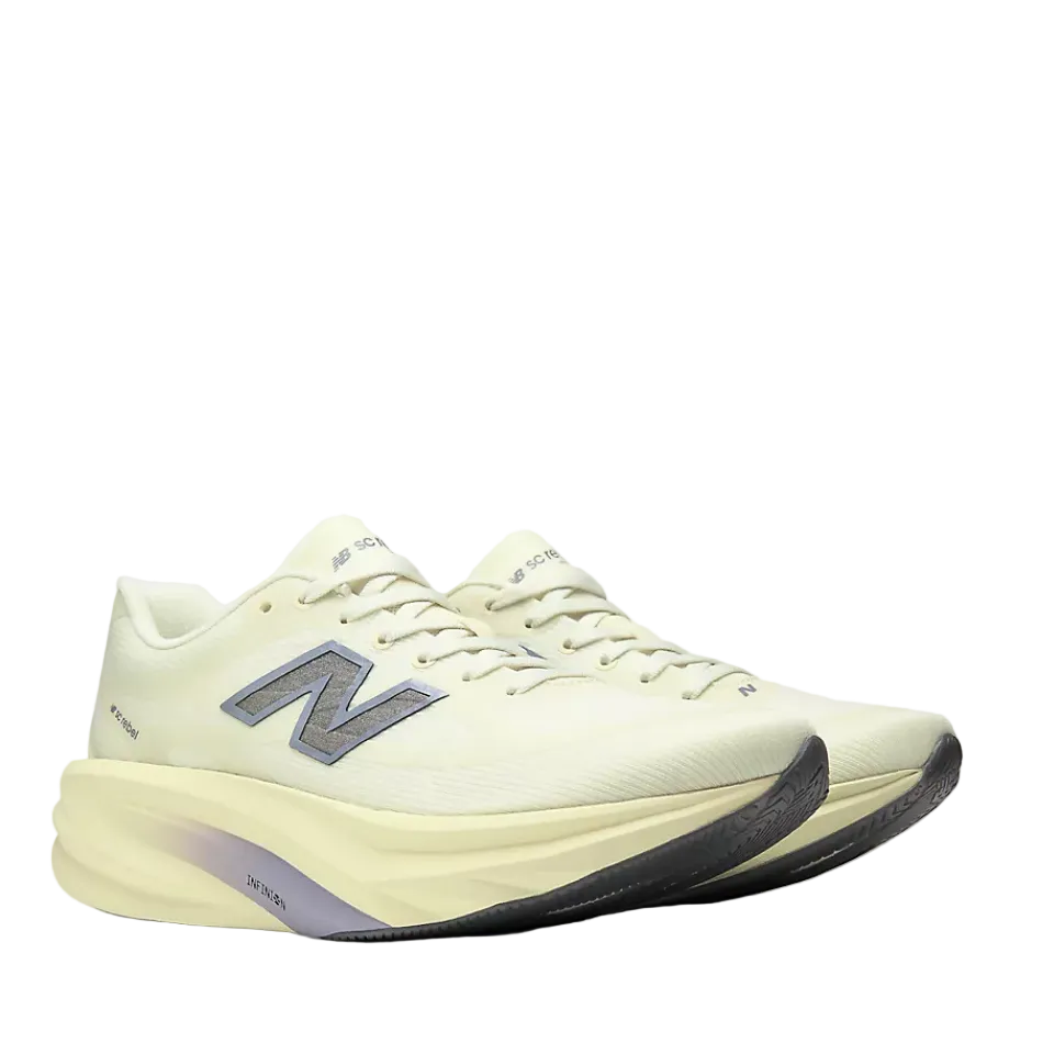 A New Balance running shoe in a light pistachio green, featuring a thick sculpted foam midsole and a metallic silver 'N' logo on the side.