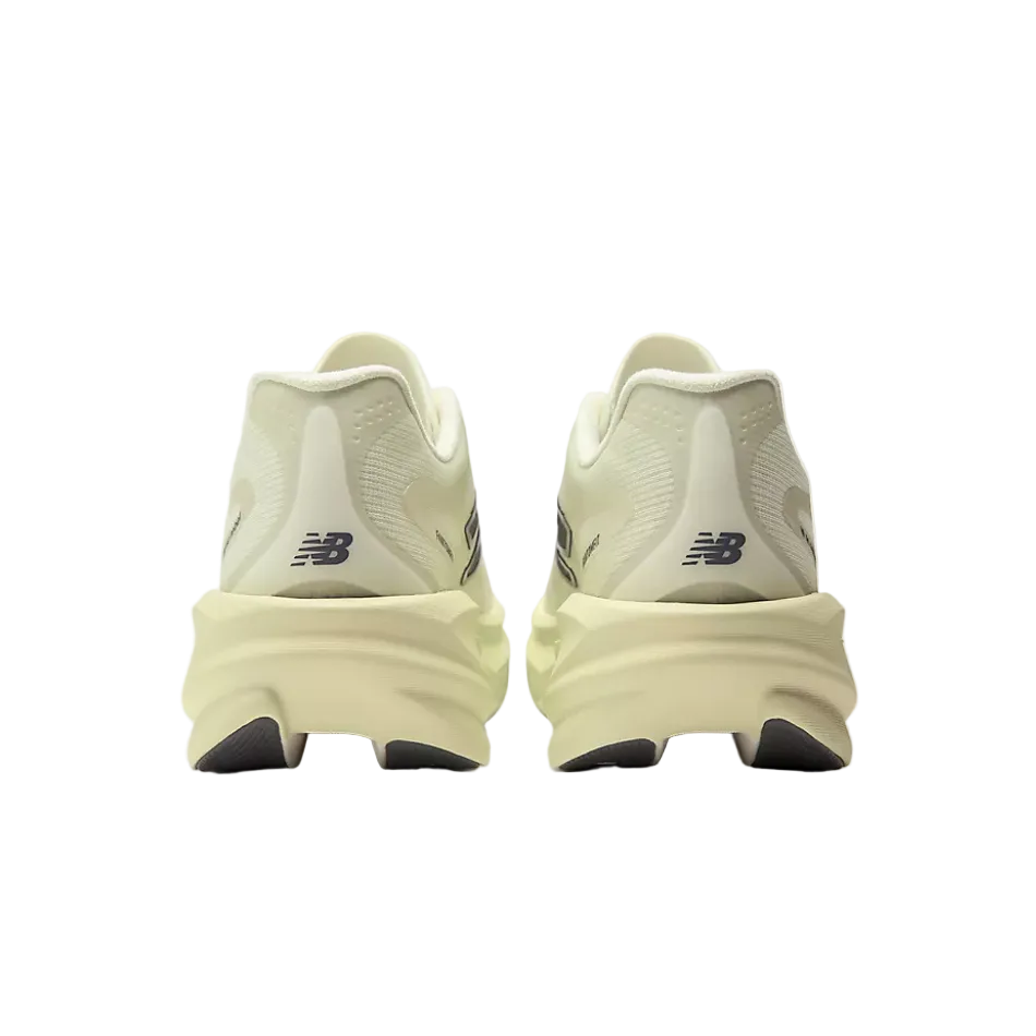 A New Balance running shoe in a light pistachio green, featuring a thick sculpted foam midsole with a New Balance logo on the heel.