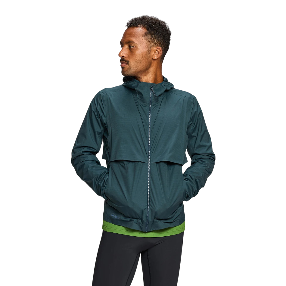 Up & Running Janji Men's Rainrunner Pack Jacket in Atlantis teal, a waterproof ripstop running shell with a hood.